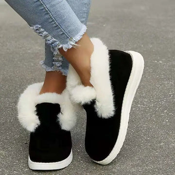 Black suede slip-on warm winter shoes with white faux fur trim and thick white rubber sole for cold weather use