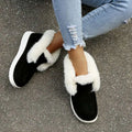 Black suede warm winter slip-on boots with plush white faux fur lining and thick white rubber sole warm winter shoes