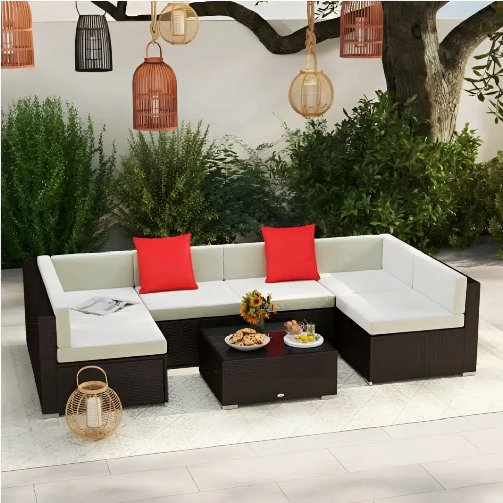 Dark brown wicker patio sectional sofa with beige cushions and red accent pillows for outdoor seating