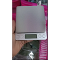 Brushed stainless steel food portable mini pocket scale with silver rectangular platform and four circular buttons below display