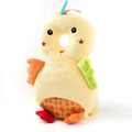 A soft pale yellow plush chick toy with orange feet and wings featured on a bunny ear mesh toddler head protection pad