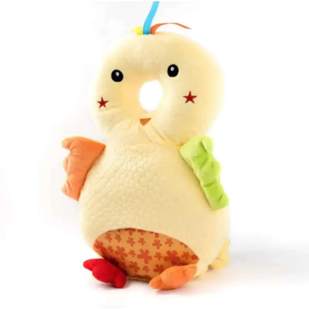 A soft pale yellow plush chick toy with orange feet and wings featured on a bunny ear mesh toddler head protection pad