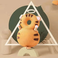 Orange tiger-shaped toddler head protection pad with brown stripes and pink paw pads made of bunny ear mesh