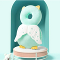 A soft mint-green plush bunny ear mesh toddler head protection pad with yellow accents and embroidered white wings