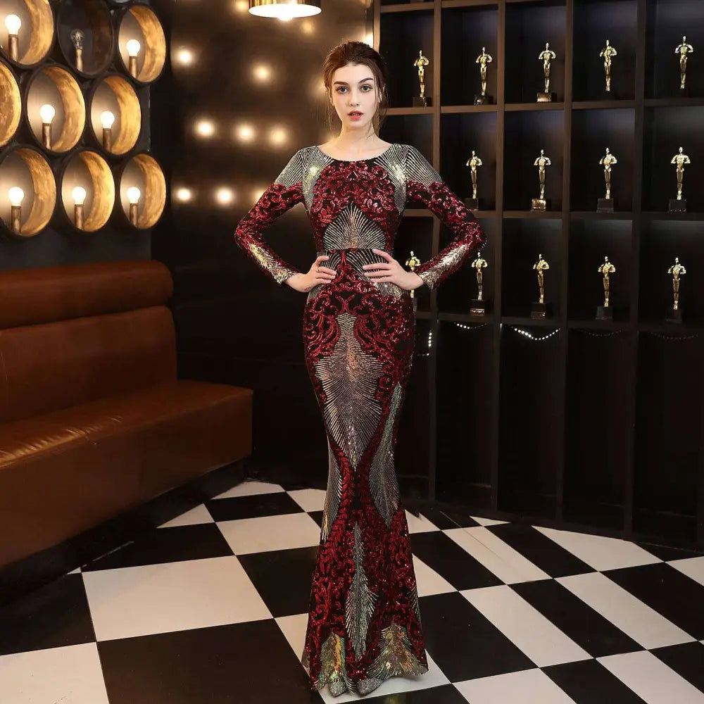 A burgundy gold mopping long sequin dress with shimmering mermaid silhouette and intricate fashion stitching mopping embroidery