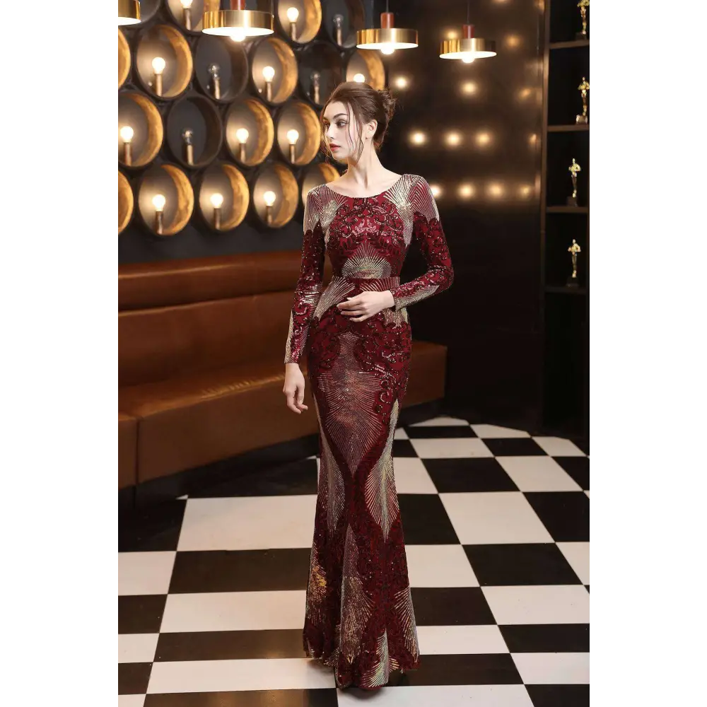 A shimmering burgundy gold mopping long sequin dress with long sleeves and fashion stitching mopping detailing