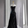 Elegant black satin strapless skirt evening gown with fitted bodice and flowing skirt for formal occasions