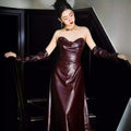 Glossy burgundy leather skirt evening gown with fitted bodice long sleeves and strapless design