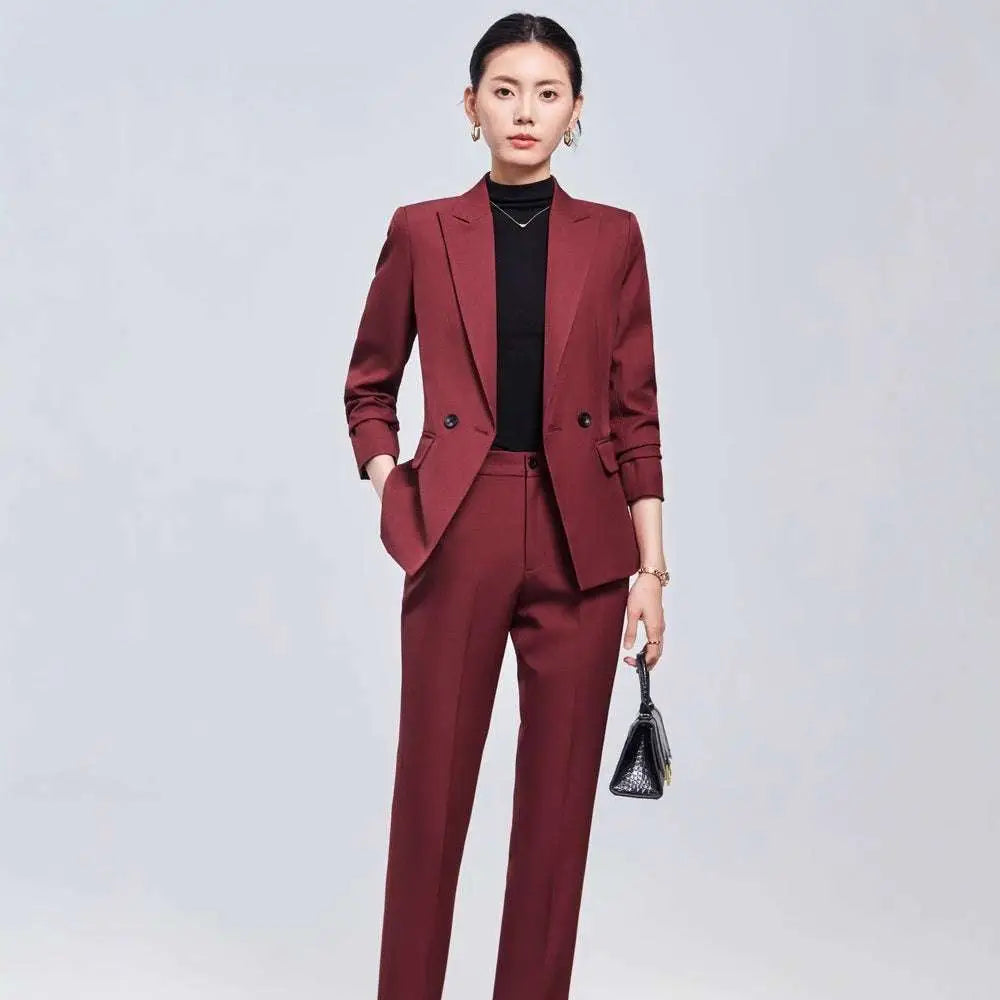 A sleek maroon burgundy long sleeve two piece set featuring a tailored blazer and matching sleeve small suit trousers