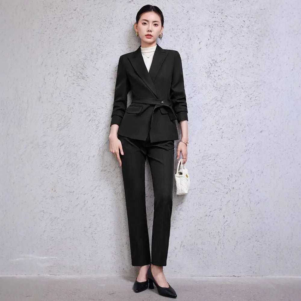 A tailored burgundy long sleeve two piece set with a belted waist blazer and matching sleeve small suit trousers