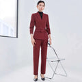 A tailored burgundy long sleeve two piece set with a belted waist blazer and matching sleeve small suit trousers