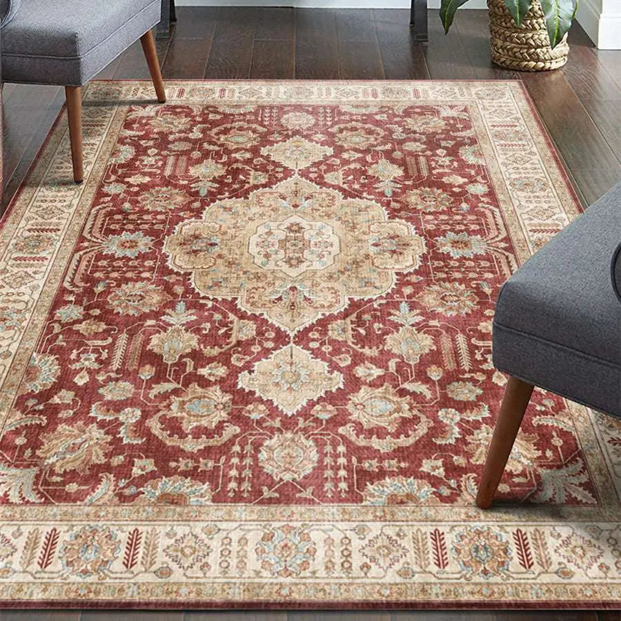 Burgundy ornate short pile area rug with intricate floral and geometric patterns and a central medallion design