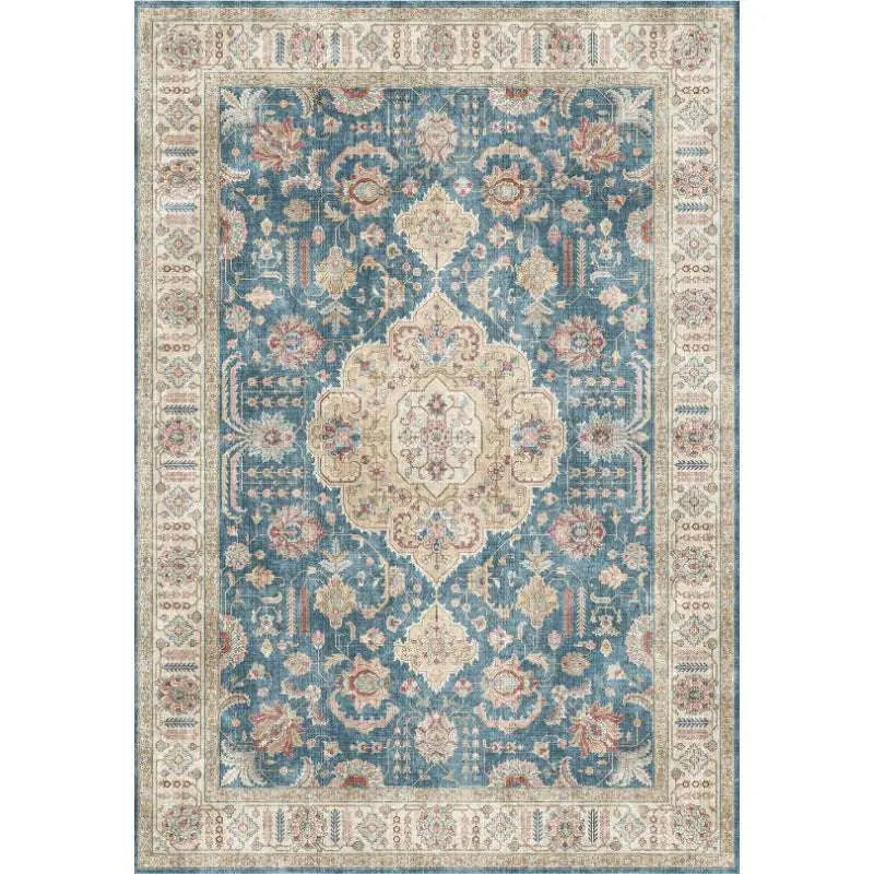 Burgundy ornate short pile area rug with faded blue field, cream and muted pink floral motifs, and geometric borders