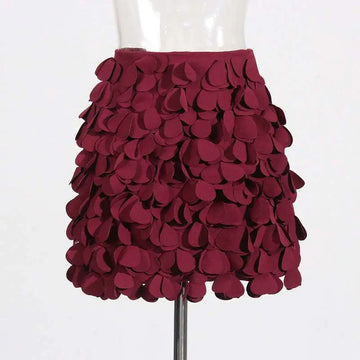 A burgundy petal design a line skirt featuring layered fabric appliqués and intricate design sense stitching wafer details