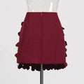 A structured burgundy petal design sense stitching a line skirt with layered ruffled fabric details and stitching wafer accents