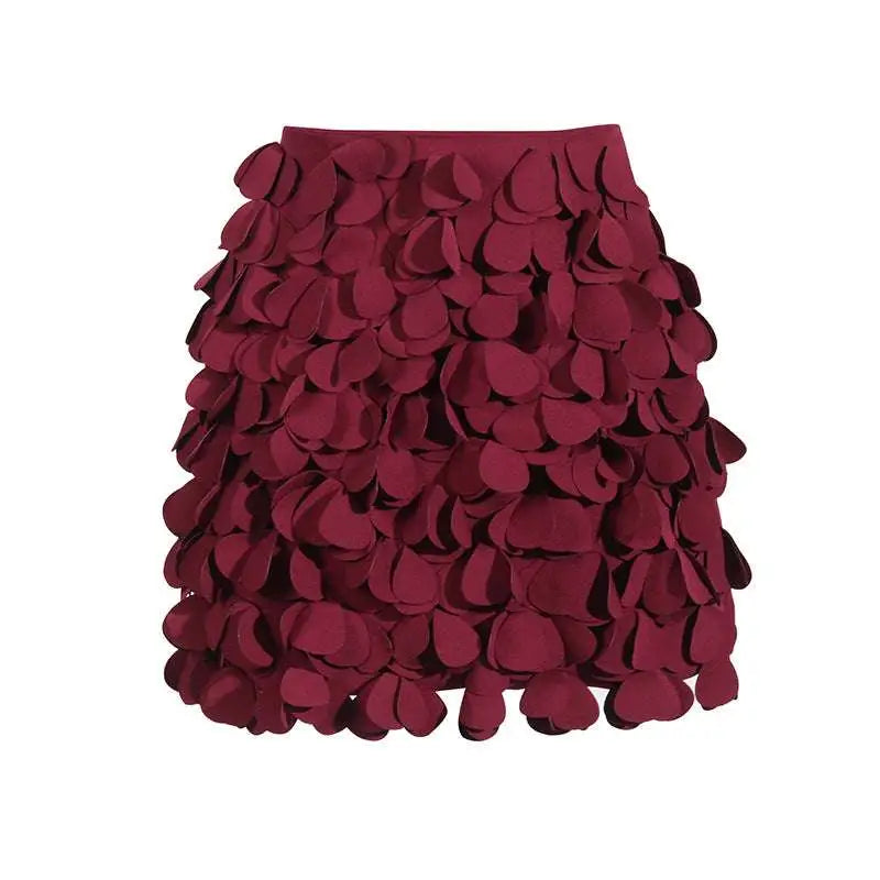 A burgundy a line skirt featuring layered petal fabric appliqués and intricate design sense stitching wafer details