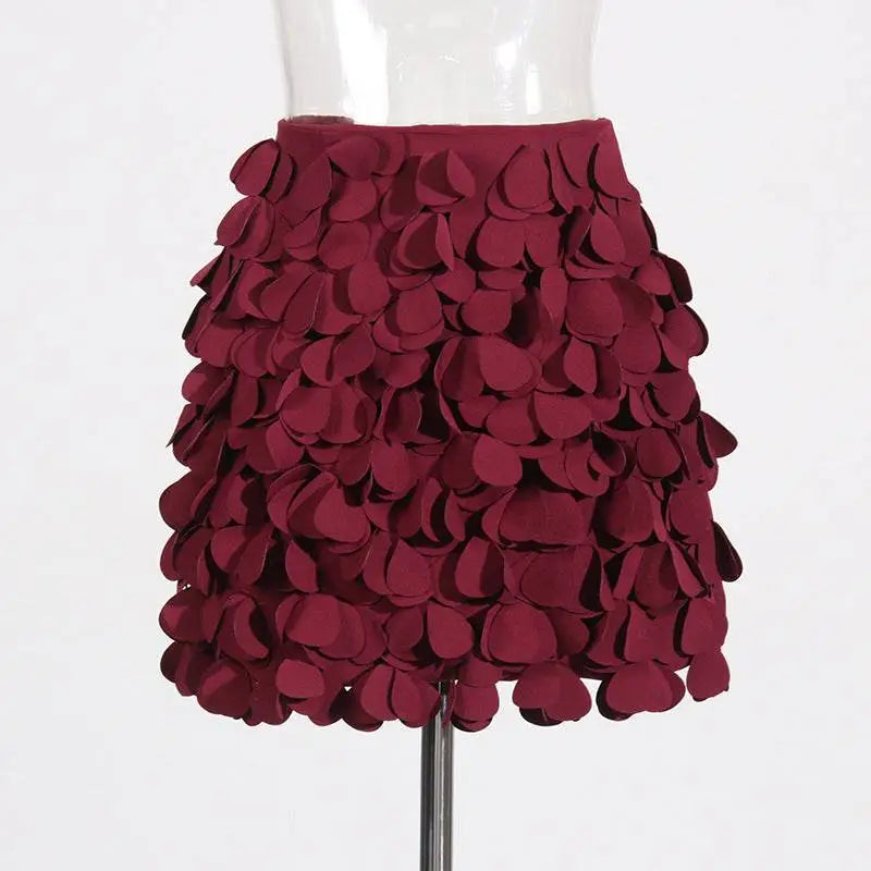 A burgundy a line skirt featuring layered petal fabric appliqués with design sense stitching wafer accents