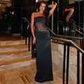 Black strapless gown with lace bodice and flowing skirt featuring y2k lace suspender design and burgundy satin accents