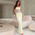 Pale green two-piece outfit with lace bodice and high-waisted skirt complementing burgundy satin y2k lace suspender dress