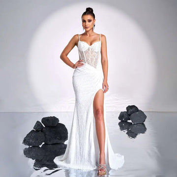 A white form-fitting mermaid gown with a lace bodice and high slit complementing burgundy sleeveless sequined high slit evening dress