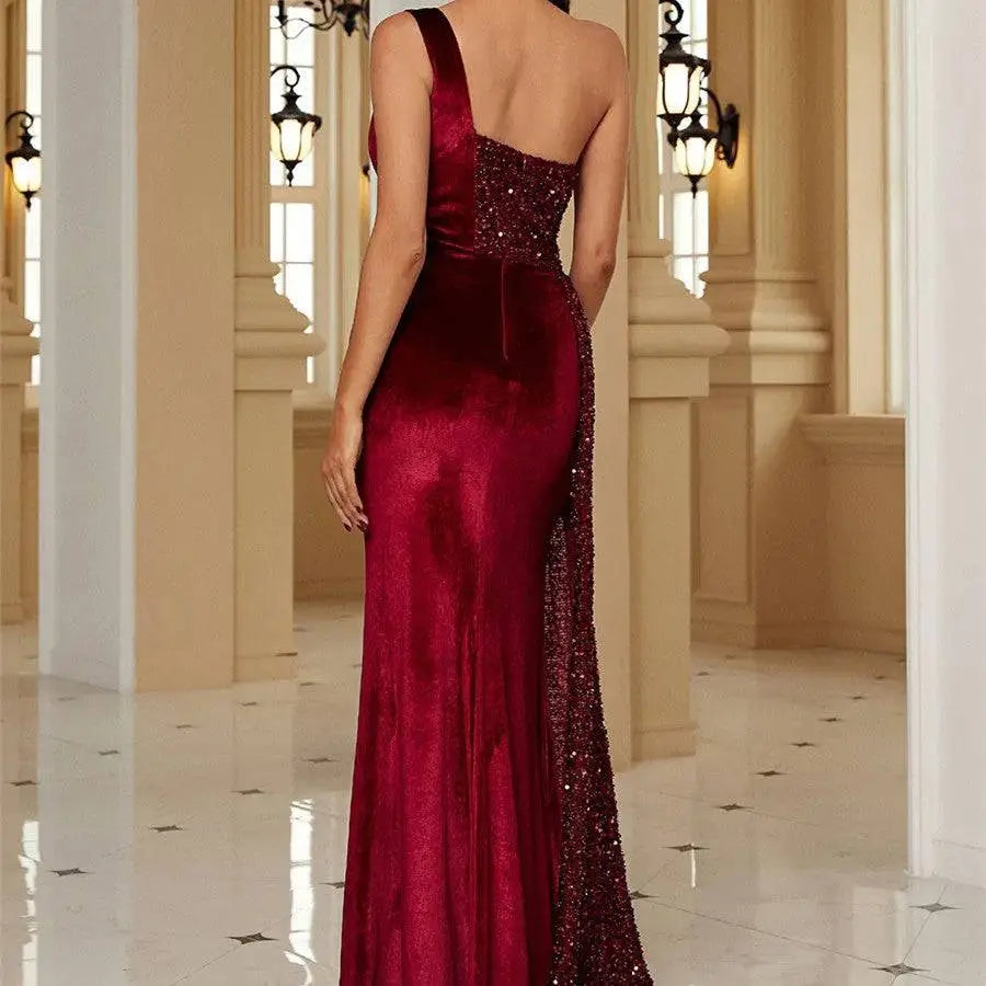 Luxurious burgundy velvet evening dress with one-shoulder design and sparkling sequin detailing on the back view