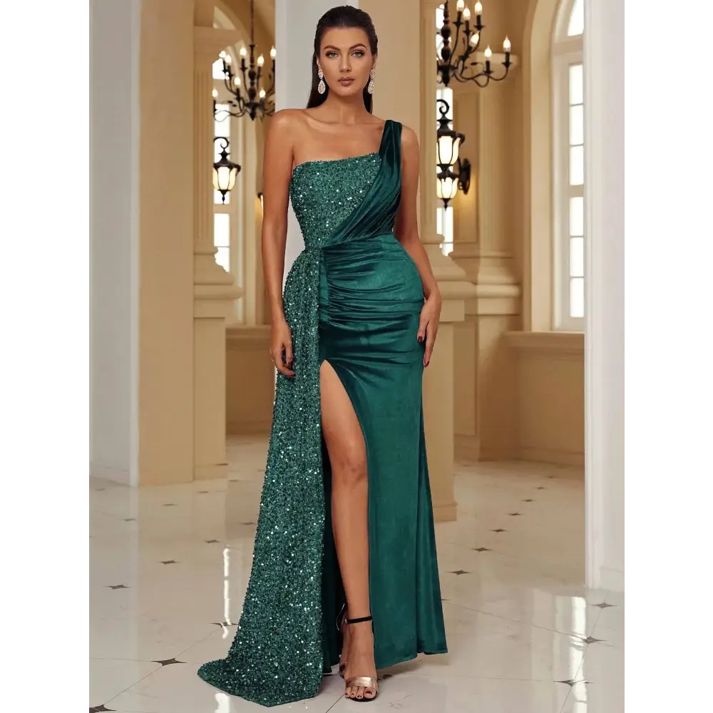 Emerald green one-shoulder evening gown with sequined bodice, satin skirt, and high slit inspired by burgundy velvet design