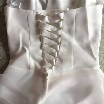 Back view of a white satin bustier korean princess beaded tulle wedding dress with lace-up ribbon detail