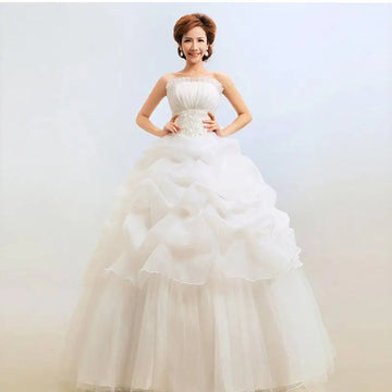 A white bustier korean princess beaded tulle wedding dress with a fitted bodice and tiered voluminous skirt