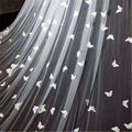 A sheer black veil bridal wedding dress featuring delicate white butterfly lace sky appliqués for formal occasions