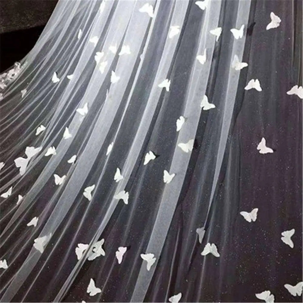 A sheer black veil bridal wedding dress featuring delicate white butterfly lace sky appliqués for formal occasions