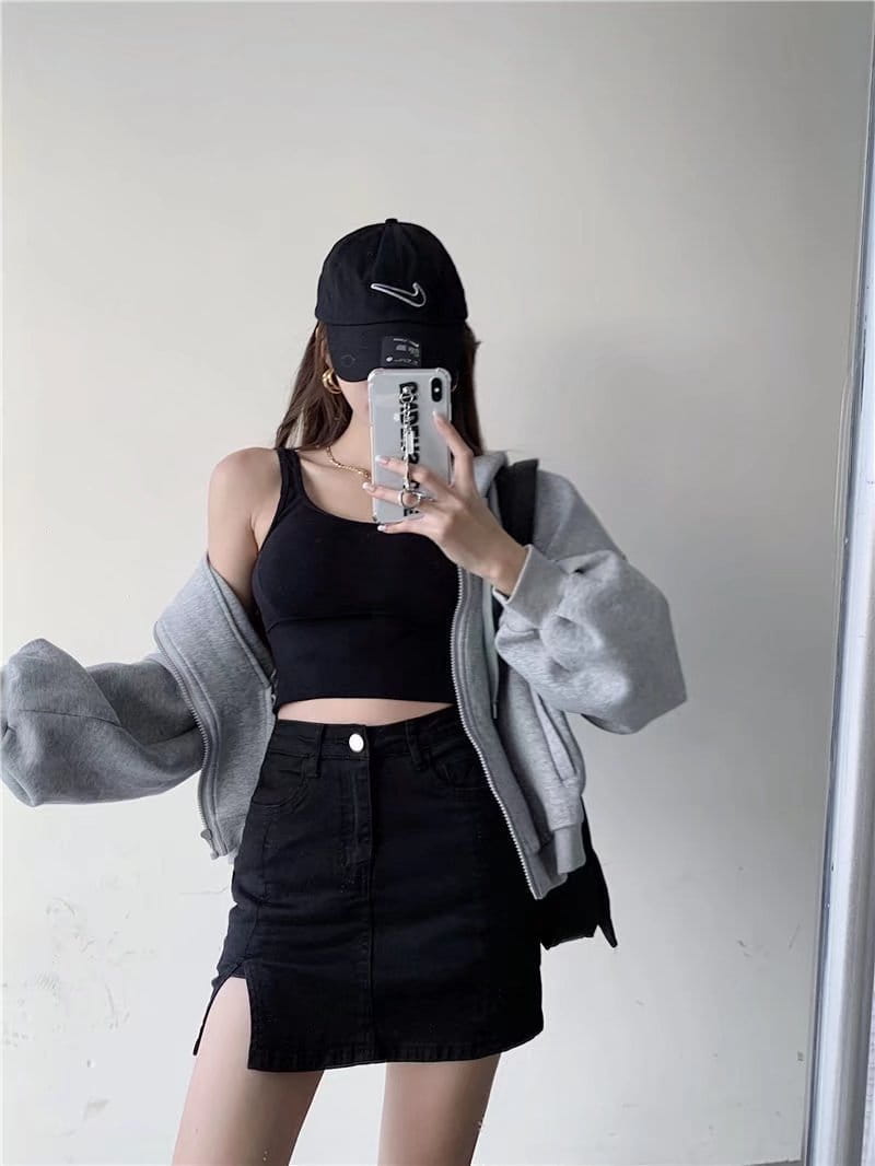 black nike baseball cap with white swoosh logo displayed alongside a distressed black denim skirt with side slit