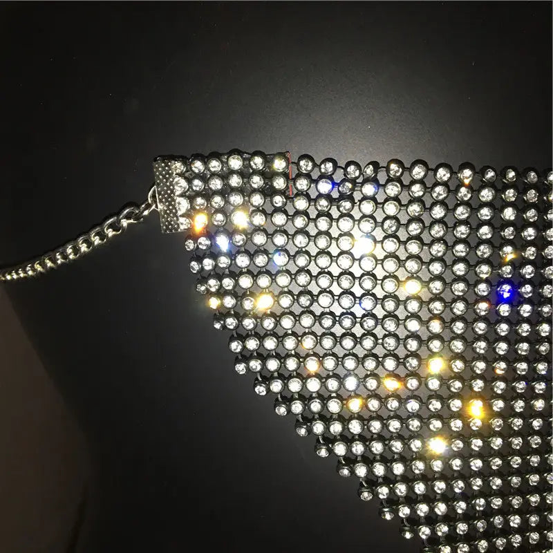 A shimmering silver mesh body chain adorned with clear and blue rhinestones and a sleek metal clasp, designed as an explosive metal flash jewelry mask.