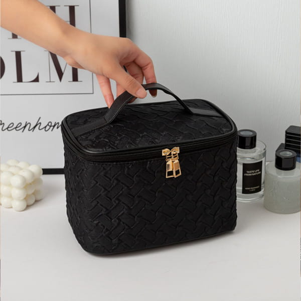 Black premium large capacity cosmetic bag made of woven textured material with gold-tone zipper pull and handle.