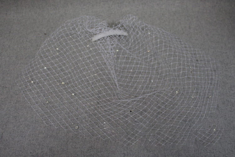 a delicate white bridal veil rhinestone featuring large hole mesh adorned with scattered sparkling rhinestones for a headdress accessory