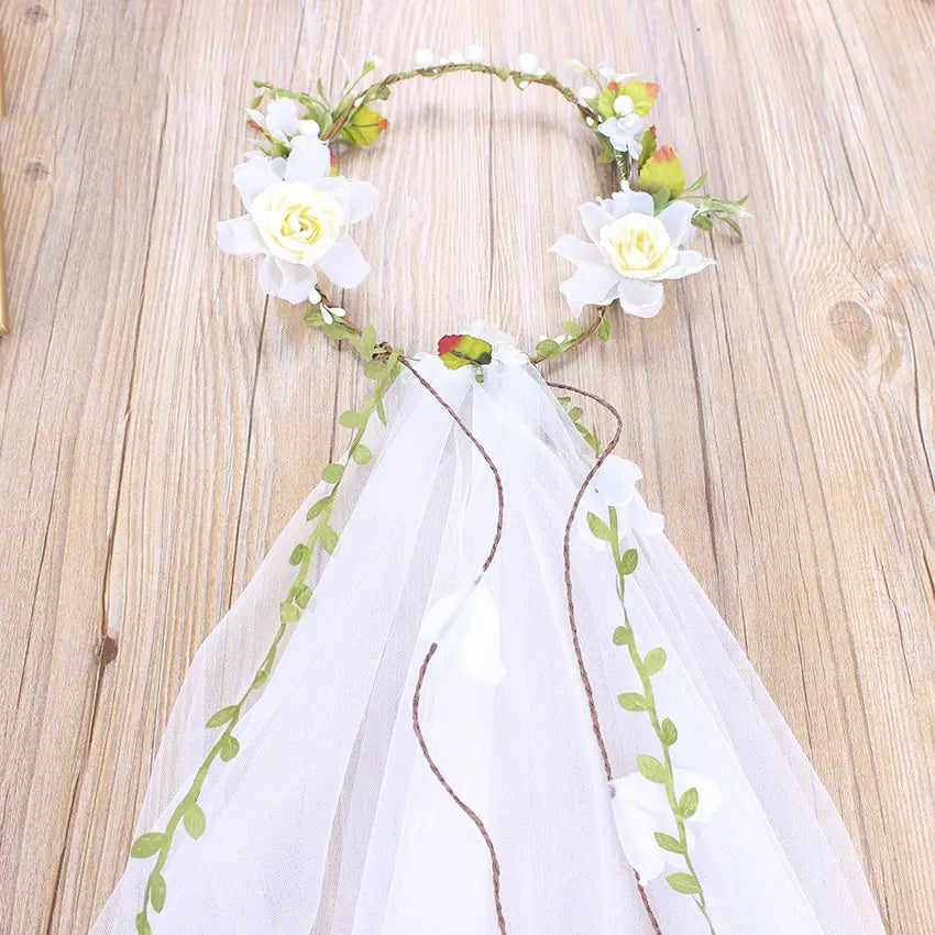 Handmade white rose bridal veil featuring a white floral headpiece with delicate lace veil and embroidered green vines.