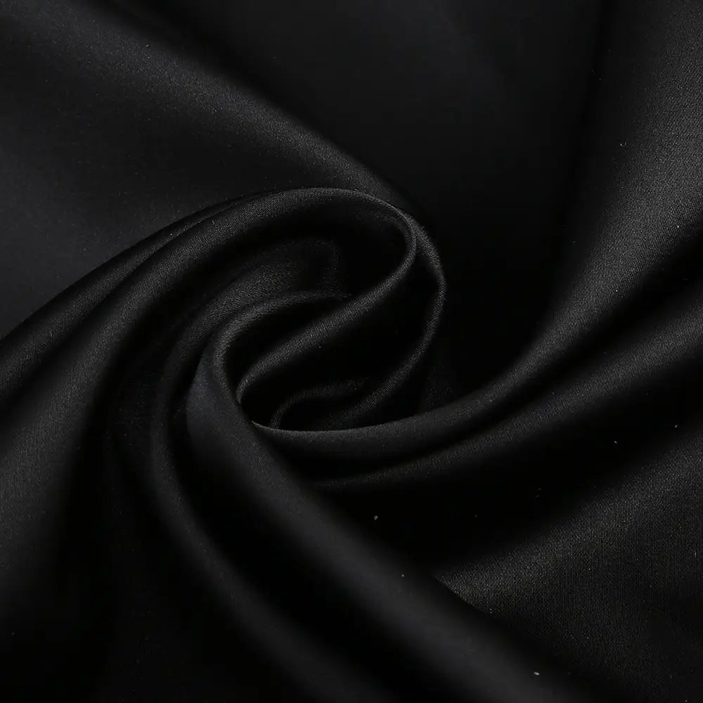 black satin fabric showcasing smooth glossy finish and flowing folds in a one-shoulder slit mop black dress two-piece set with set sexy lacing detailing