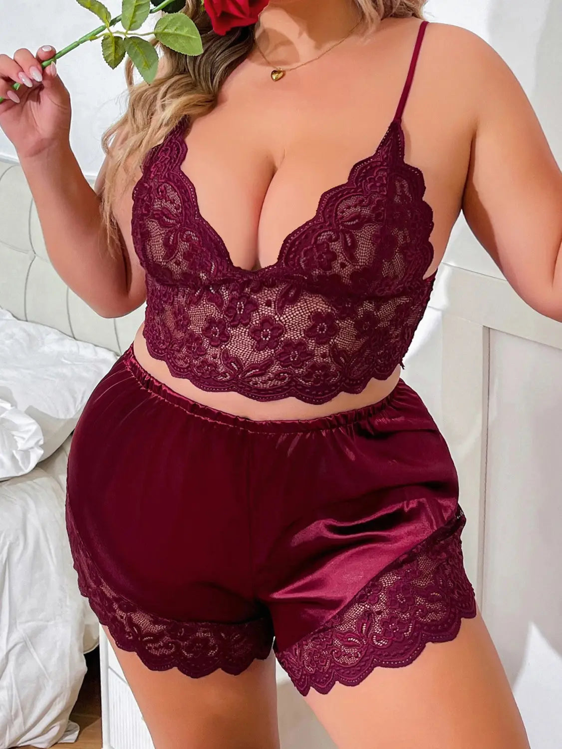Maroon lace strap plus size two-piece suit featuring a lace strap bra and satin shorts with scalloped edges.