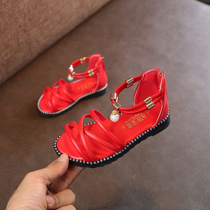 western style red girls sandals with pearl charm feature a glossy leather-like upper, gold-toned buckles, pearl accents, and a black rubber sole edged with rhinestones, ideal for net red princesses.