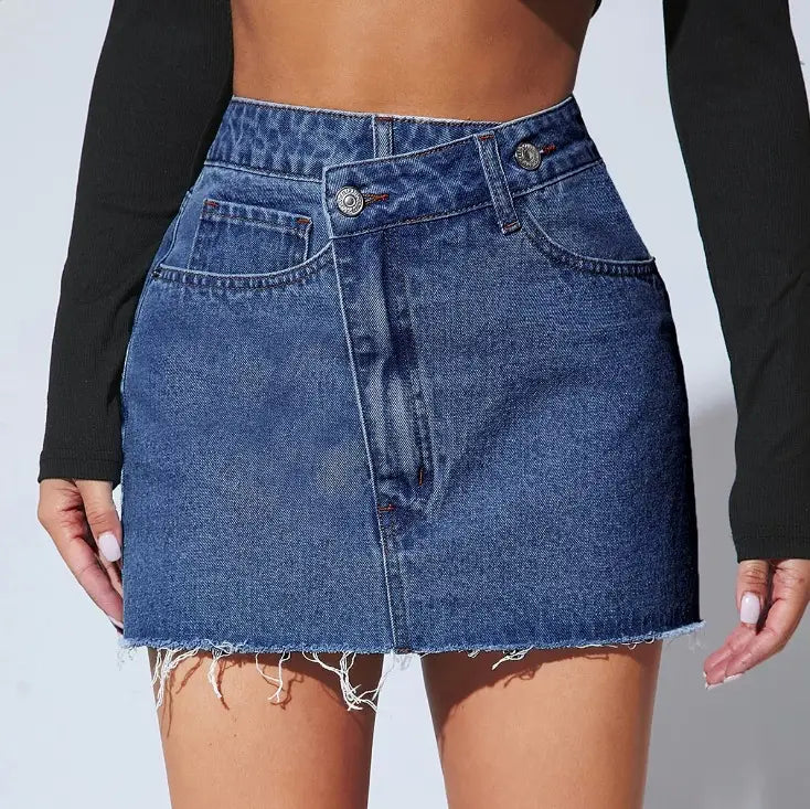 A mid-waisted fashion irregular denim short skirt in blue featuring a frayed hem and classic button closure.