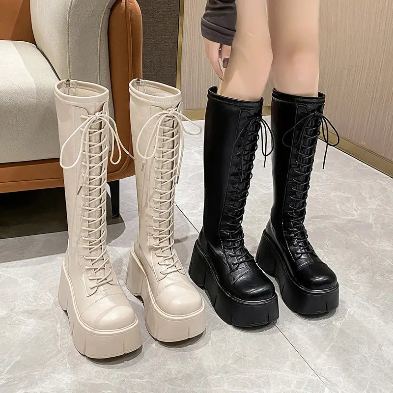 Fashion white platform lace up high boots in cream and black with thick soles and lace detailing.