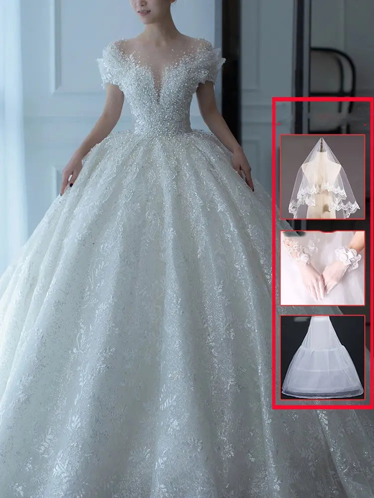 White lace wedding veil with delicate scalloped edge and sheer overlay as part of an off shoulder lace wedding dress piece set.