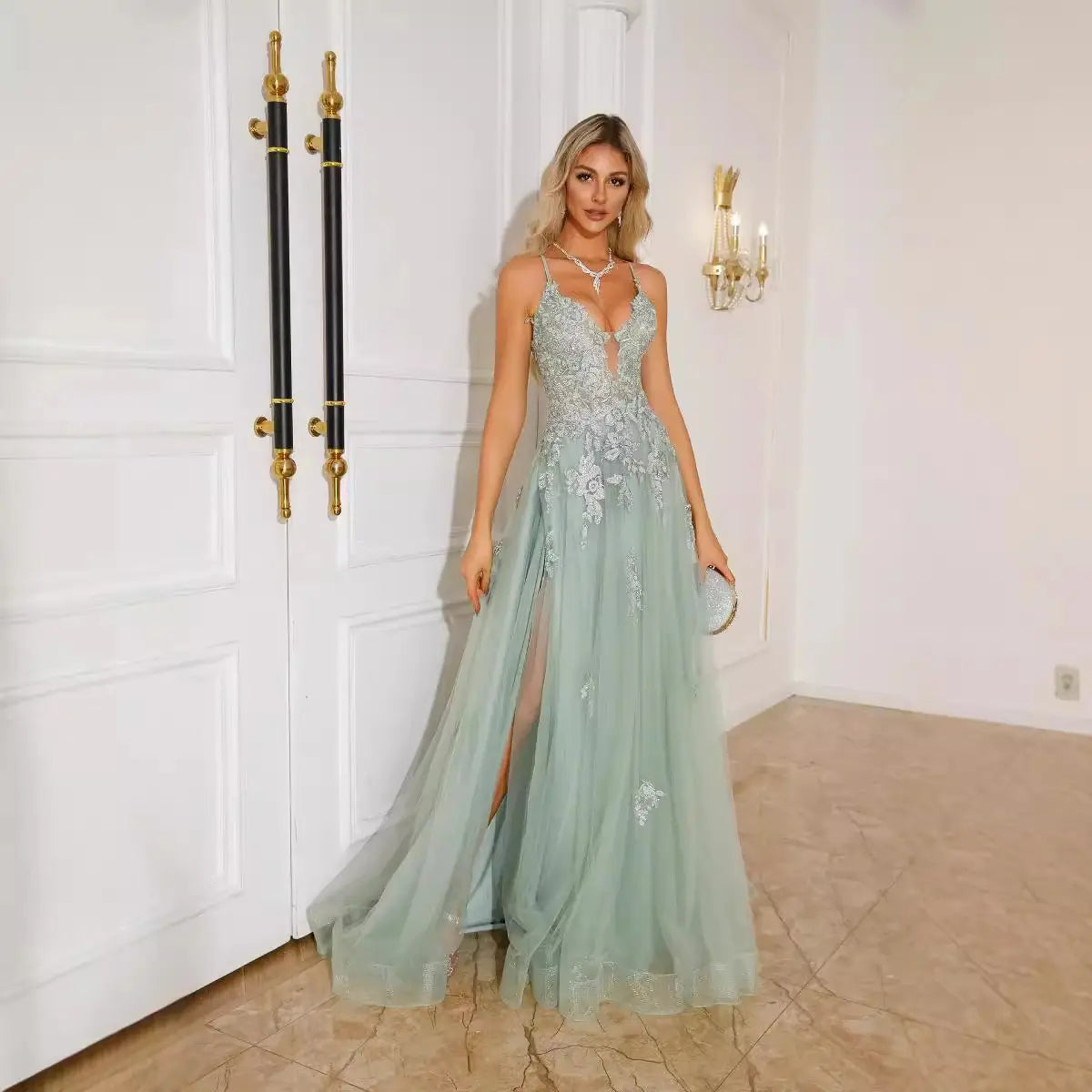 A shimmering light blue women evening dress with intricate silver floral embroidery and a flowing tulle skirt in the picture color suitable for evening dresses suspender styles.