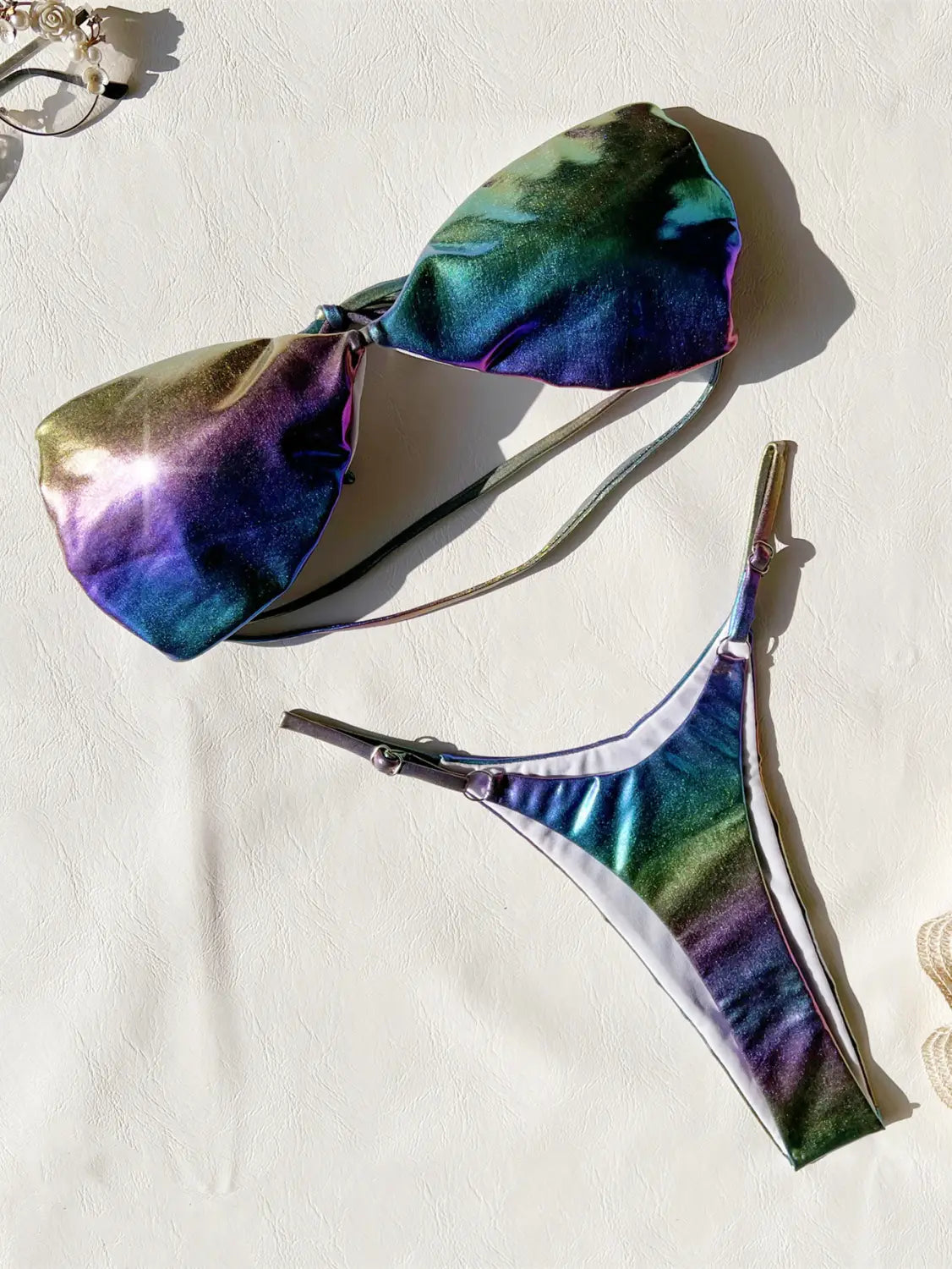 Iridescent rainbow-hued metallic bikini gradient swimsuit featuring a shimmering tie-dye pattern.
