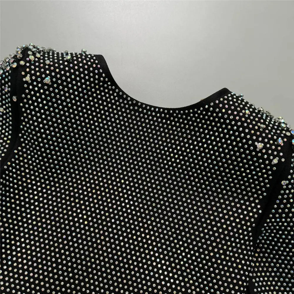 Black sexy rhinestone bandage long sleeve mini dress featuring a dense pattern of sparkling silver rhinestones across the shoulders and bodice for a stylish cross border foreign look.