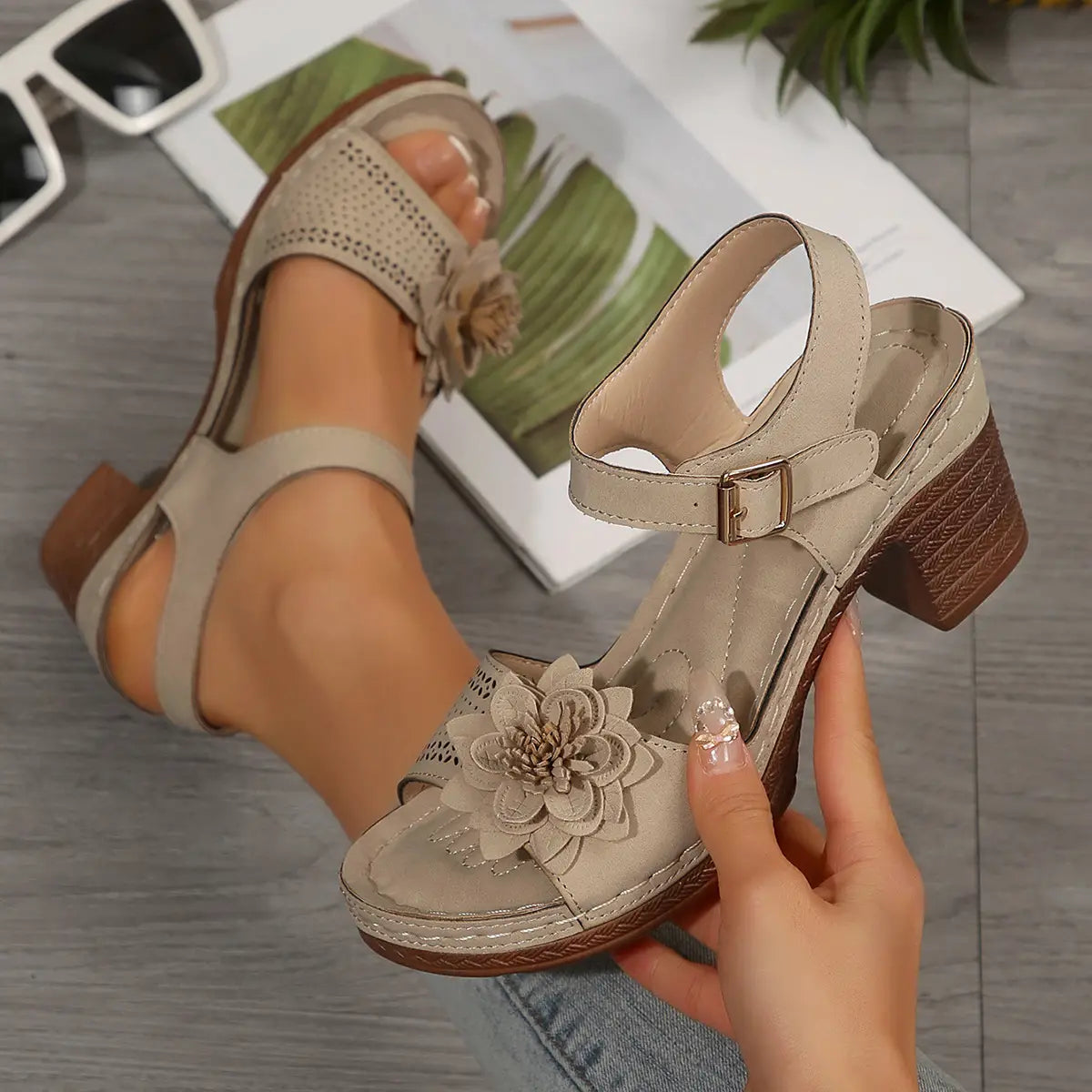 Beige leather chunky heel sandals with a textured block heel and decorative floral appliqué on the toe strap ideal for heel sandals summer.