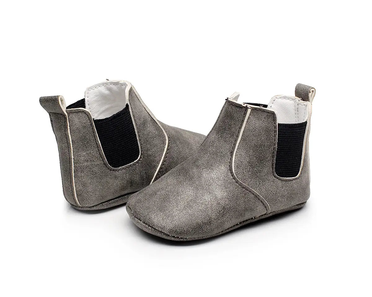 gray suede chelsea baby shoes baby with black elastic side panels and white stitching from the baby xie shoes collection