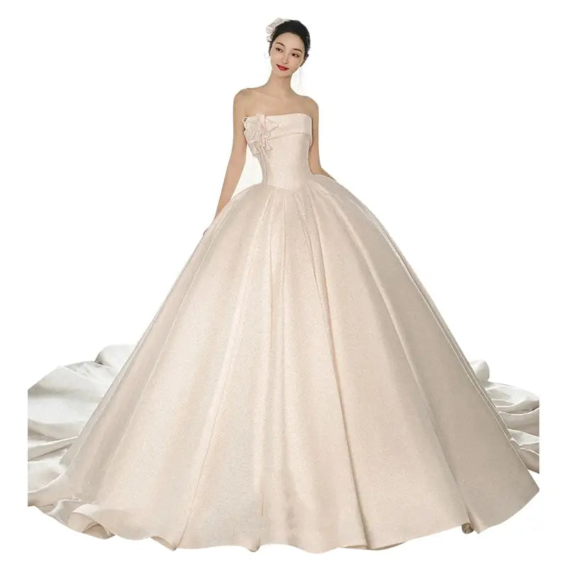 A strapless ivory satin dress featuring a fitted bodice with embroidered floral detail and a big train in luxury women’s fashion.