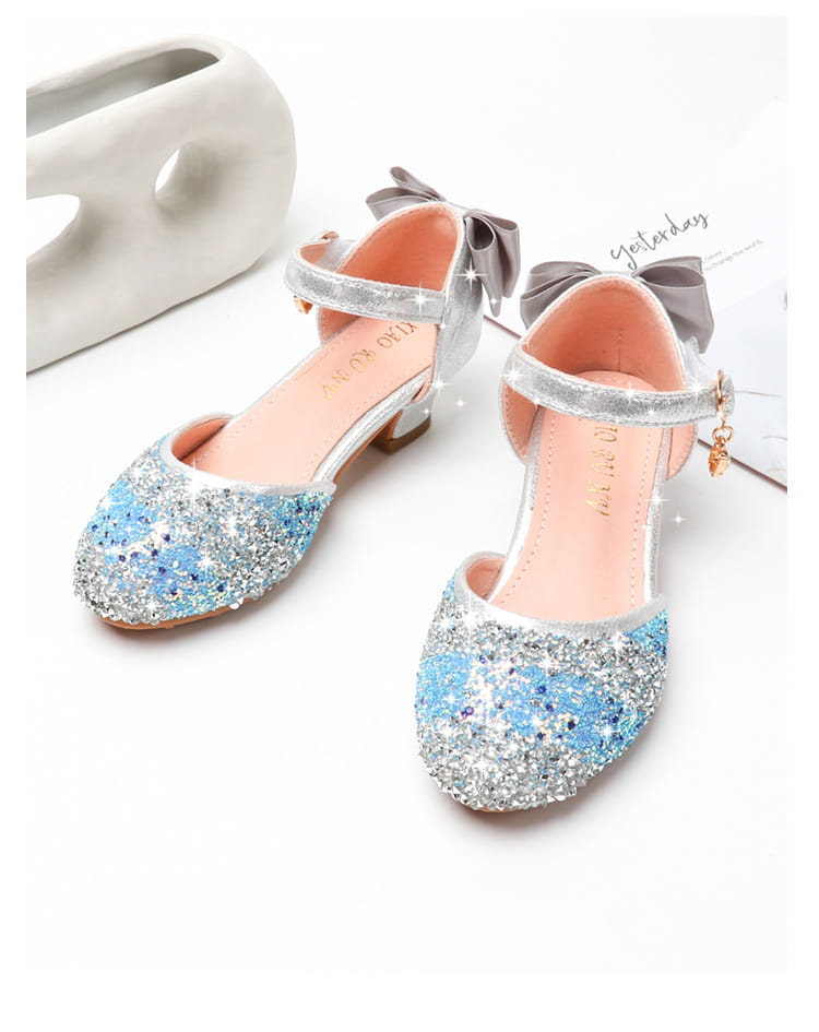 sparkling blue and silver glittery girls high heel summer sandals with a gray bow on the ankle strap featuring rhinestone accents.