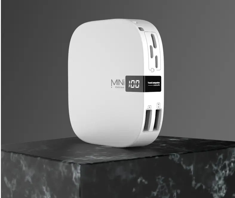 White mini power bank 10000mAh with digital scale display showing 100 percent charge and multiple USB ports designed for travel use.
