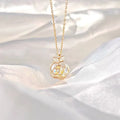 A delicate gold-toned camellia advanced design silver rose necklace with a rose pendant featuring clear gemstones